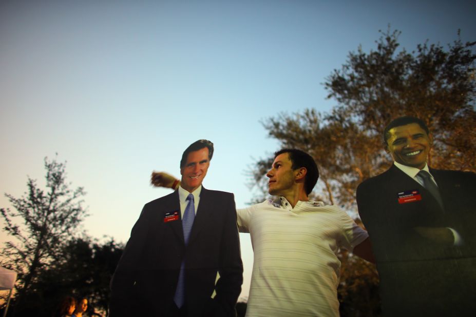 Bartek Wawruch stands between cardboard cutouts of Obama and Romney at Lynn University in Boca Raton, Florida, on Saturday, October 20, as the campus prepares for Monday's presidential debate.