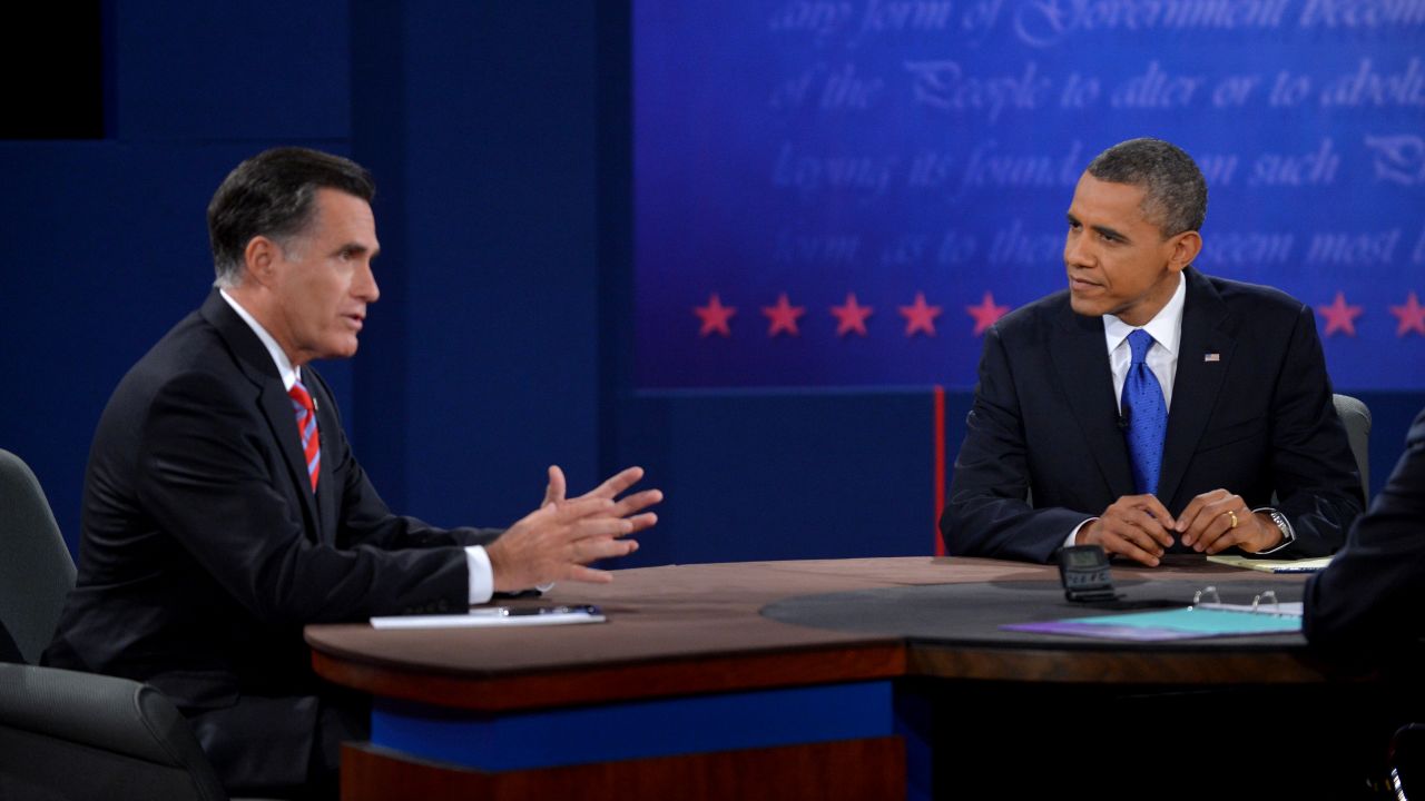 Obama listens as Romney responds to a question Monday.