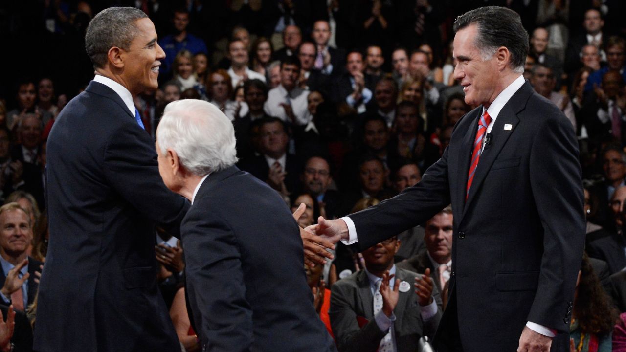 Obama and Romney greet each other as they join Schieffer on stage.