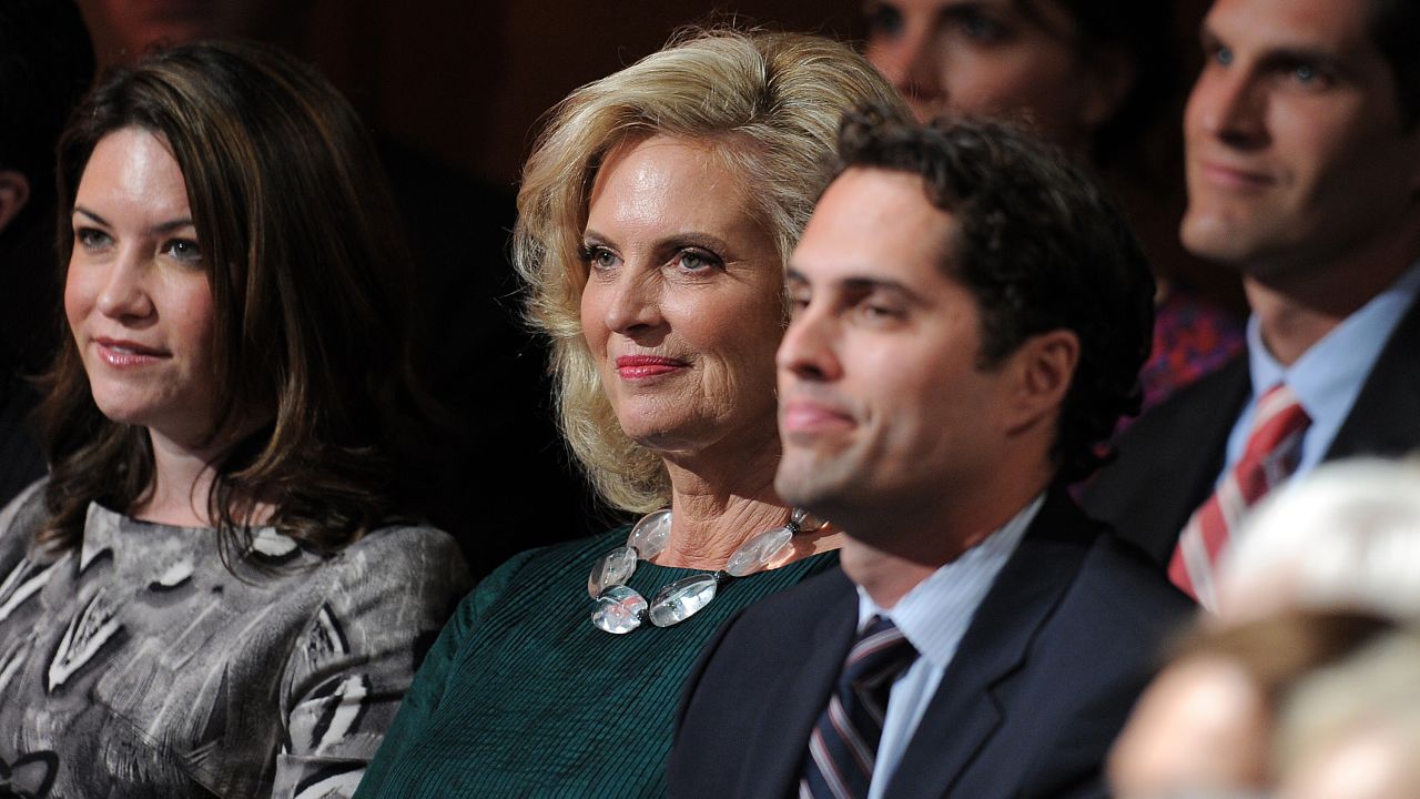 Ann Romney, center, and other members of the Romney family take their seats.