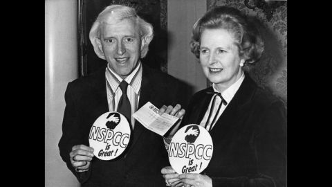Savile poses with British Prime Minister Margaret Thatcher at a National Society for the Prevention of Cruelty to Children fund-raising presentation in 1980.