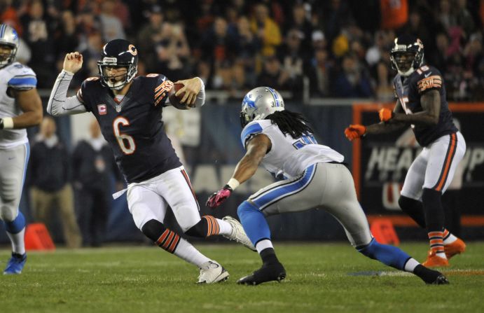 No. 6 Jay Cutler of the Bears runs against the No. 36 Jonte Green of the Lions.