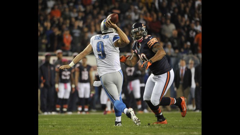 No. 90 Julius Peppers of the Bears pressures No. 9 Matthew Stafford of the Lions.