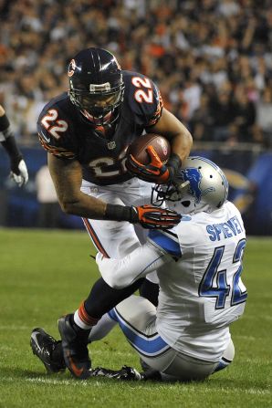 No. 22 Matt Forte of the Bears runs for 40 yards and is tackled by No. 42 Amari Spievey of the Lions.