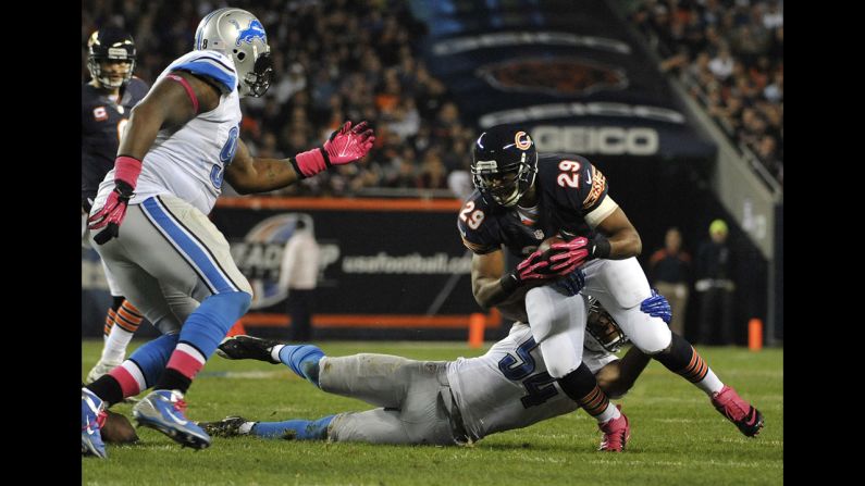 No. 29 Michael Bush of the Bears is tackled by No. 54 DeAndre Levy of the Lions.