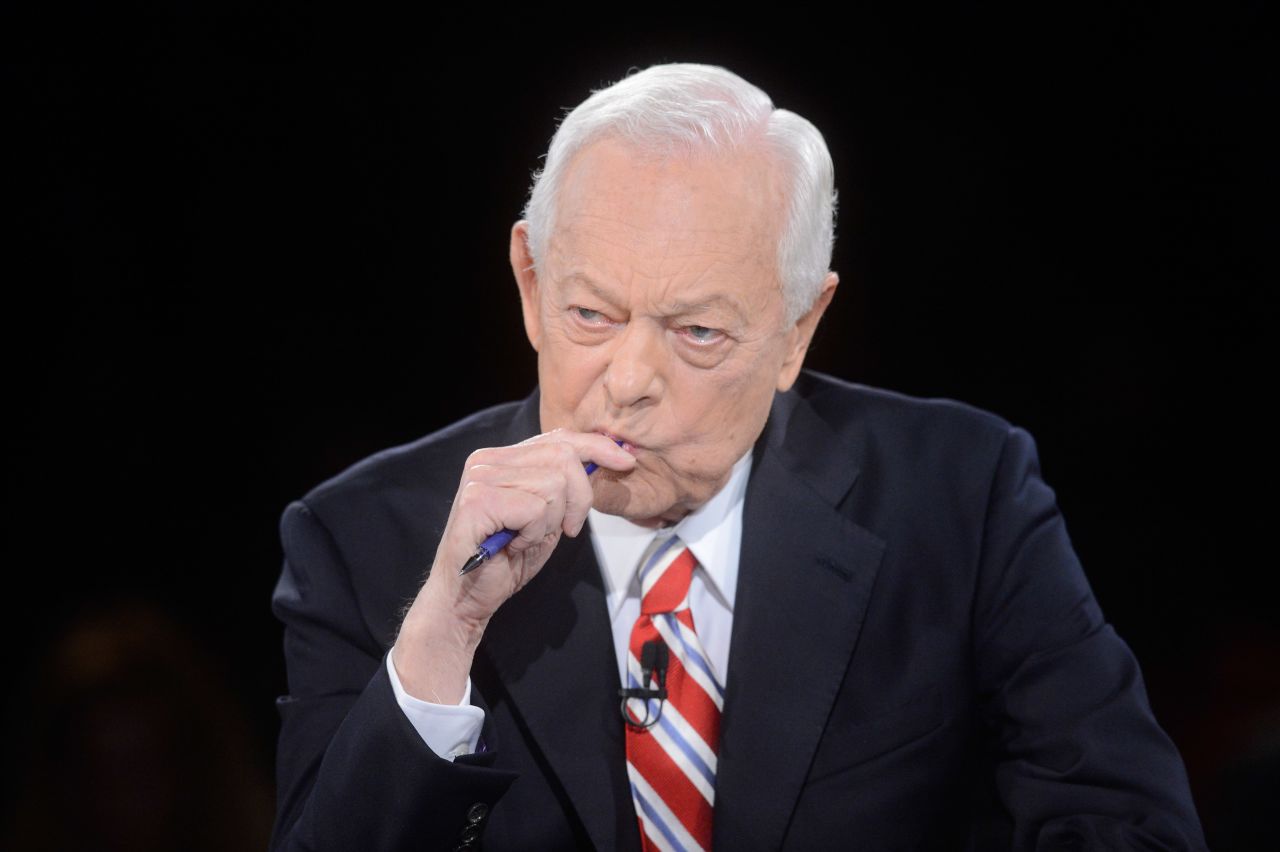 Schieffer listens to the candidates' responses during the debate.