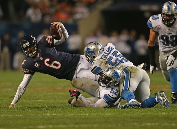 No. 6 Jay Cutler of the Bears is sacked by No. 52 Justin Durant and No. 55 Stephen Tulloch of the Lions.