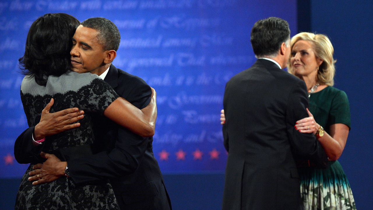 Obama and Romney hug their wives on stage after the debate.