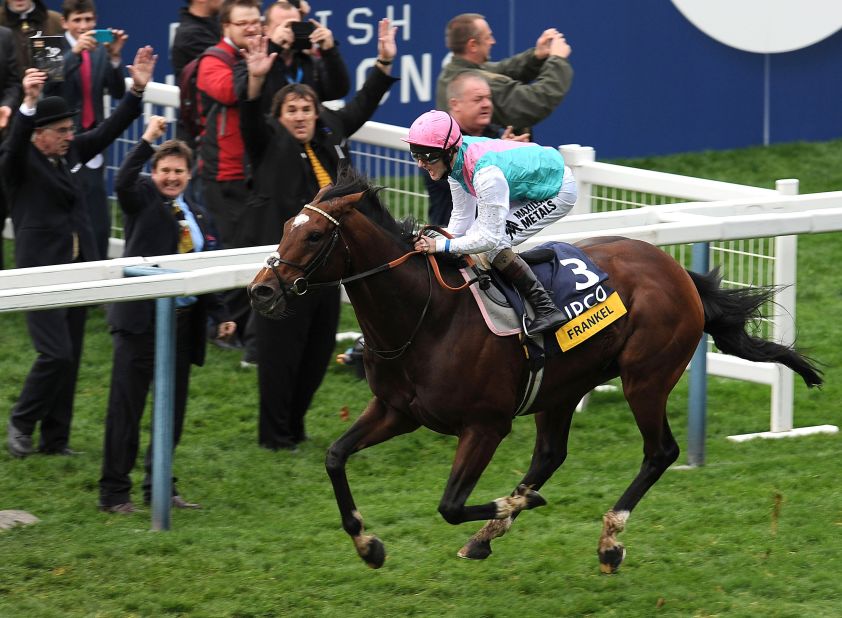 British colt Frankel powers home to take the Champion Stakes at  Ascot -- his 14th consecutive win.
