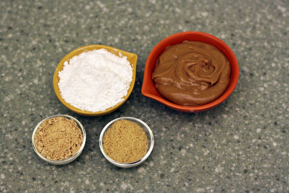 Here's a trade secret: Most of the big manufacturers of peanut butter cups add extra flavor and texture to their peanut butter filling by adding peanut meal to the peanut butter. This also creates a drier, crumblier texture that many people have come to expect in peanut butter cups. The best way to replicate this at home is by adding a combination of peanut flour and graham cracker crumbs to the peanut butter in the recipe. You can use one, both or neither. Peanut flour is available at many specialty food shops and online retailers.