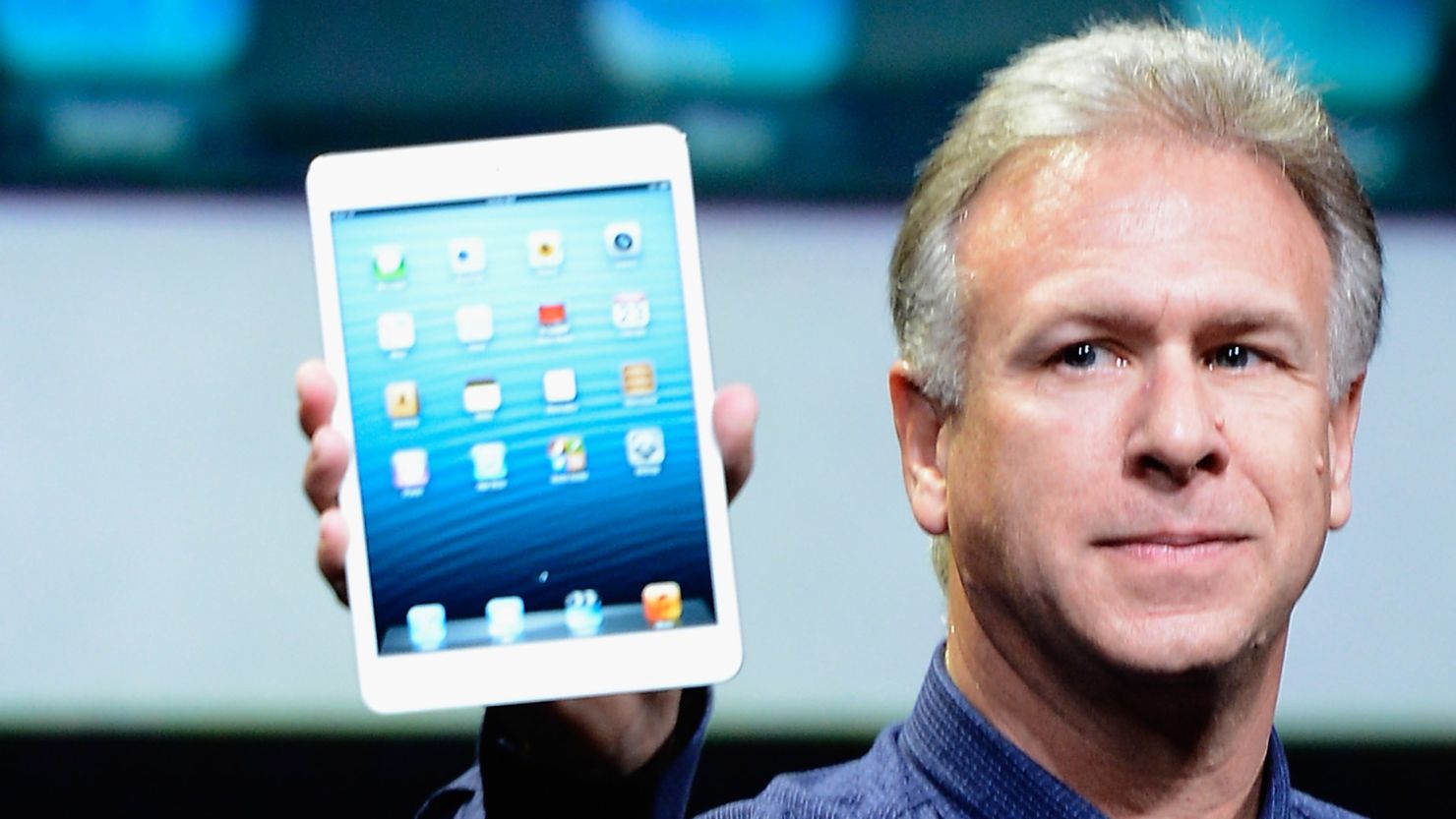 Apple marketing chief Phil Schiller holds up an iPad Mini, the company's newest gadget. 