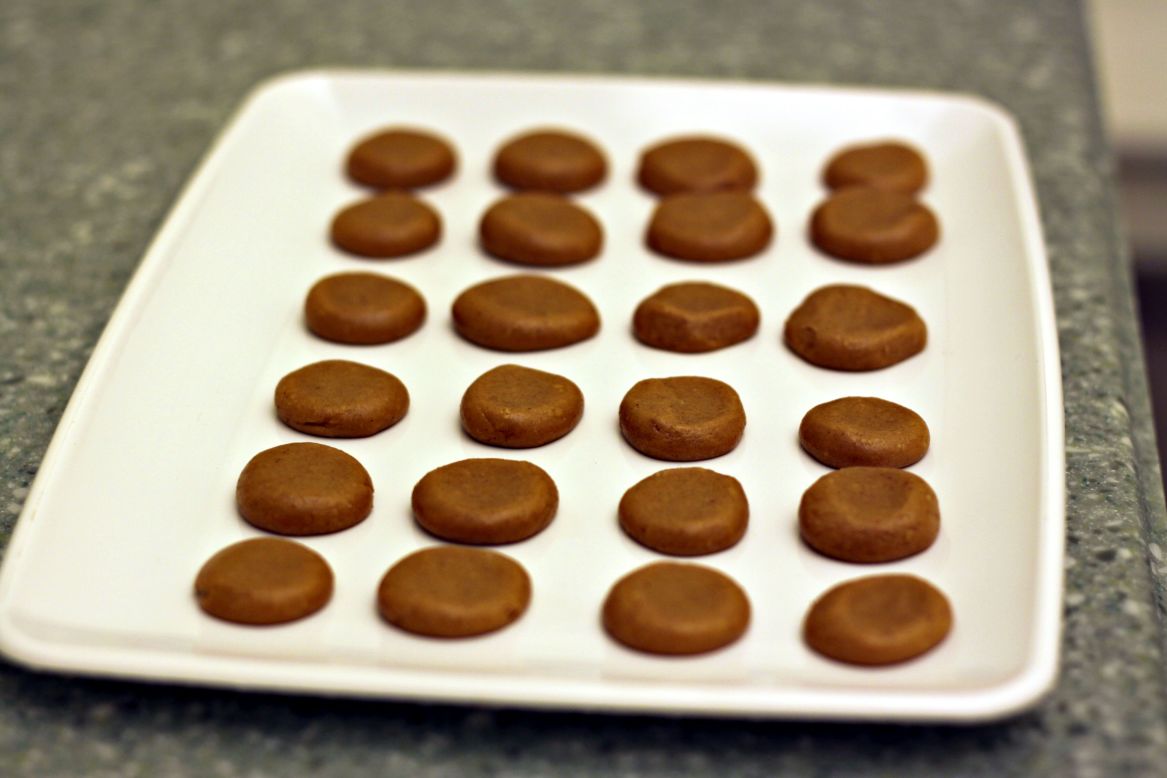 The confectioners' sugar, peanut butter, peanut flour and graham cracker crumbs are combined and rolled into discs that will ultimately become the center of the peanut butter cup.