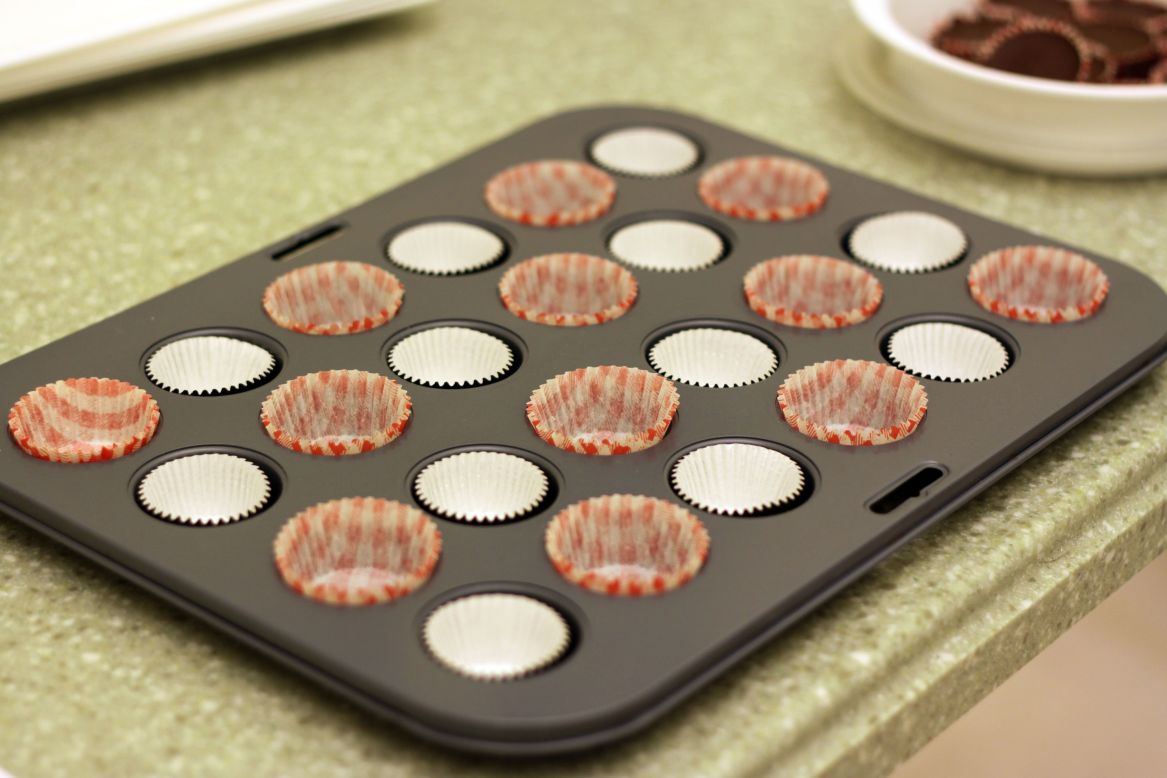 Start by lining a mini-muffin tin with baking liners. You can also trim traditional cupcake liners and use a standard cupcake tin to make wider peanut butter cups.