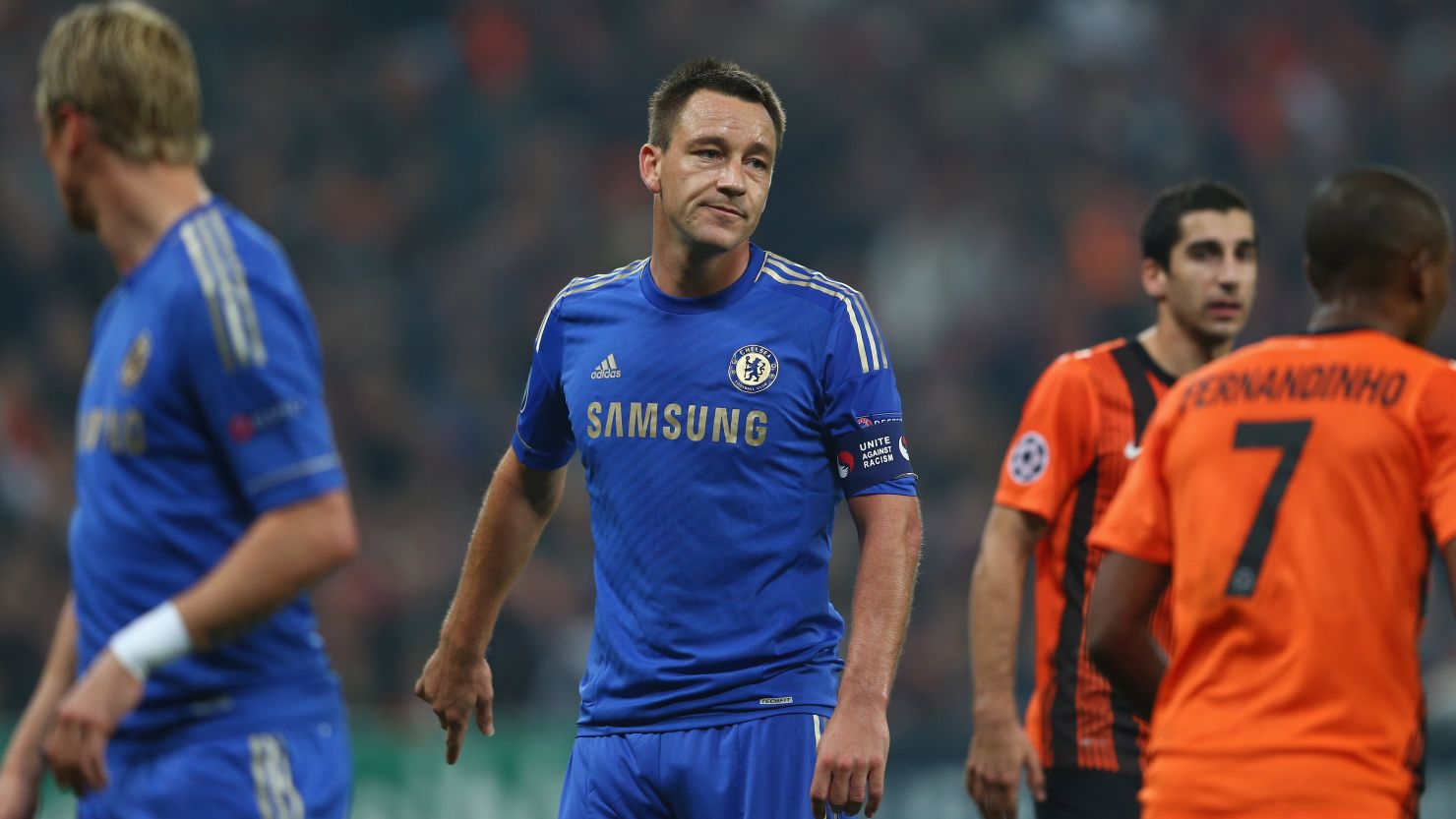 Chelsea suffer their first Champions League defeat since winning the trophy in May, as captain John Terry wears an anti-racism armband a year to the day after racially abusing an opponent in the Premier League. 