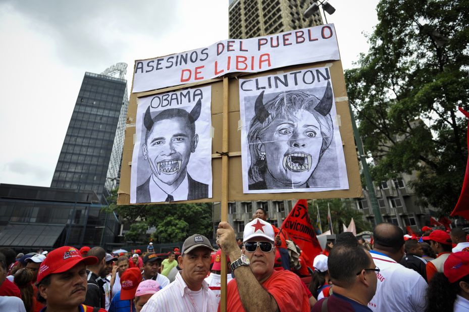 Despite Chavez's recent endorsement of Obama, not everyone approves of the job Washington is doing. Here, protesters hold a poster reading "killers of Libyan people" with portraits of Barack Obama and Hillary Clinton in Caracas, Venezuela, on April 13, 2011.