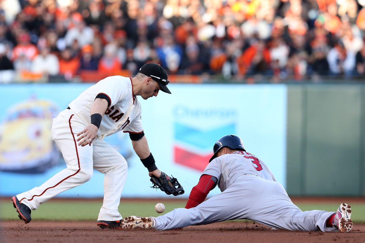 No. 3 Carlos Beltran of the Cardinals steals second base safely under a tag attempt by No. 19 Marco Scutaro of the Giants in the first inning.