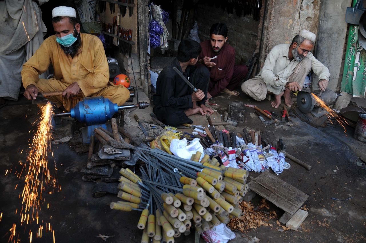 Blacksmiths sharpen various tools and knives to be used to sacrifice animals on Monday in Peshawar, Pakistan.
