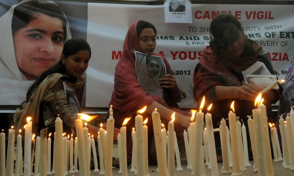Pakistani human rights activists light candles during a Sunday, October 21, 2012, vigil for Malala Yousufzai in Lahore. 