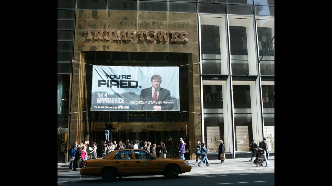An advertisement for the television show "The Apprentice" hangs at Trump Tower in 2004. The show launched in January of that year. In January 2008, the show returned as "Celebrity Apprentice."