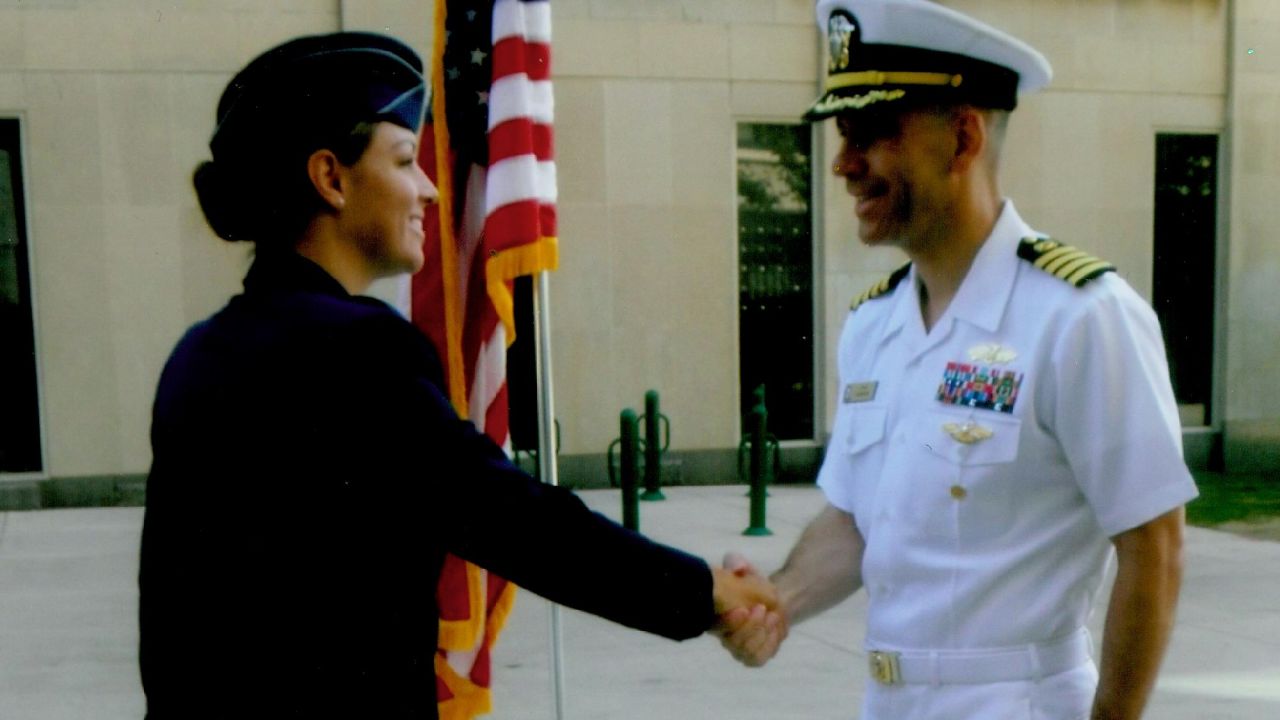 Rebecca Edmonds shakes her father's hand after her commissioning as an Air Force officer.