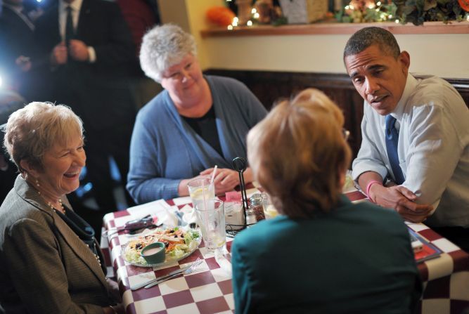 The president speaks with residents during a lunch with a group of Obama for America volunteers at an unanounced stop at Antonella's Pizzeria in Davenport, Iowa, on Wednesday.