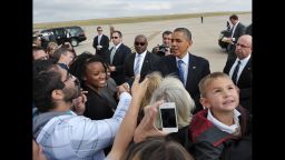 US President Barack Obama greets well-wishers October 24, 2012 upon arrival at Buckley Air Force Base in Aurora, Colorado. AFP PHOTO/Mandel NGAN        (Photo credit should read MANDEL NGAN/AFP/Getty Images)