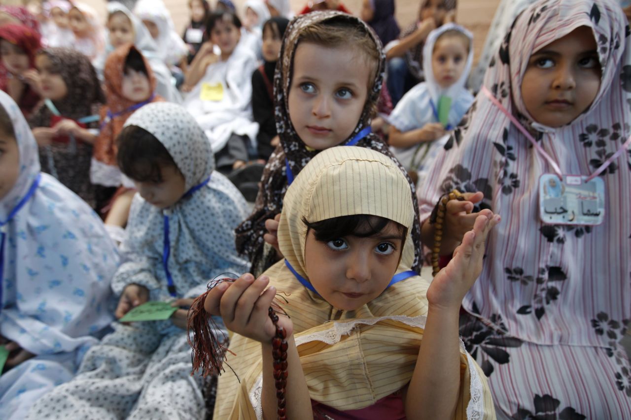 Palestinian children gather around a makeshift cube representing the holy Kaaba in Gaza City on Monday in a training sesson for children on how to celebrate the hajj pilgrimage.