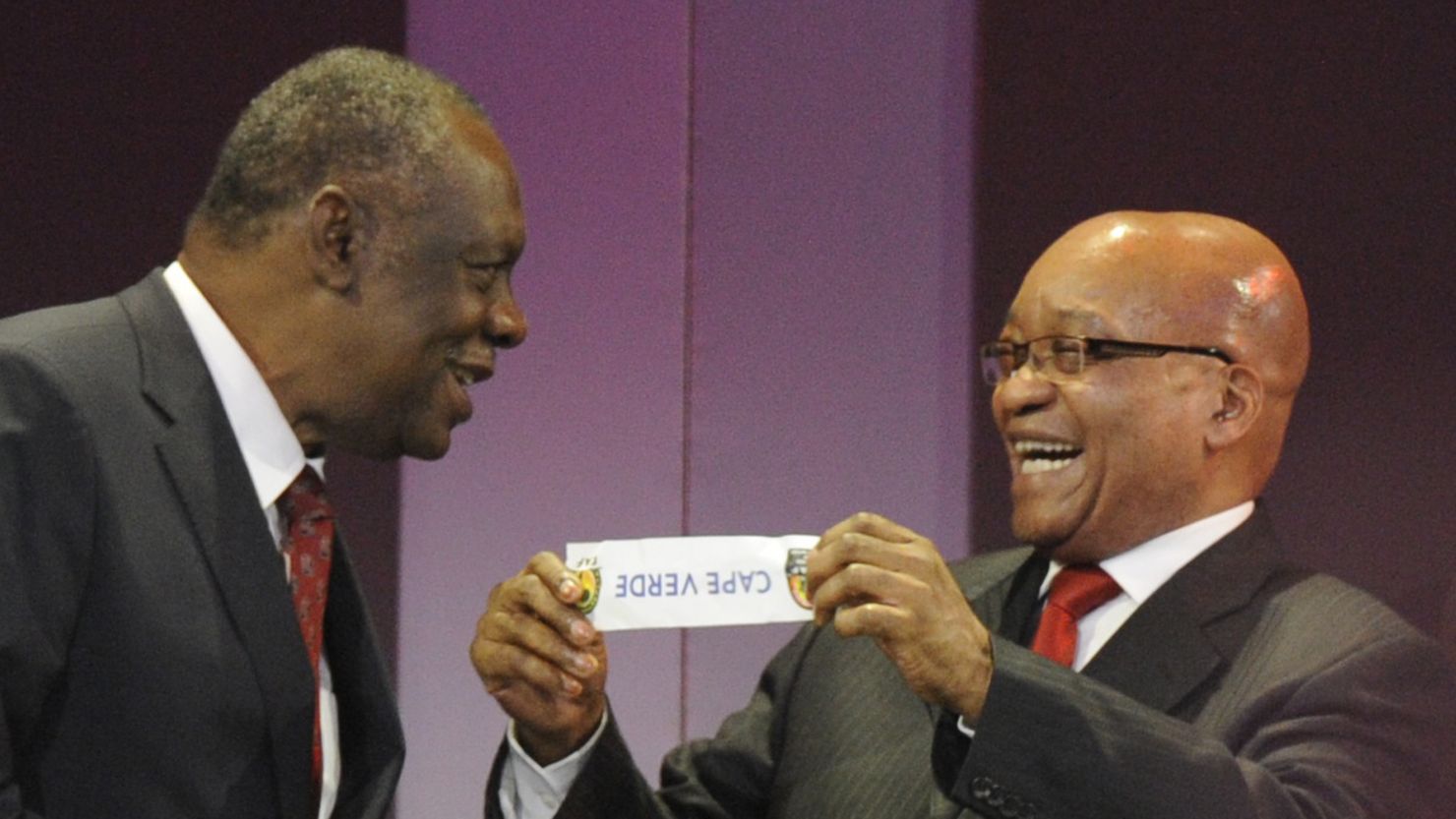 South African President Jacob Zuma holds up a piece of paper bearing Cape Verde's name to Confederation of African Football chairman Issa Hayatou during Wednesday's Africa Cup of Nations draw in Durban. 