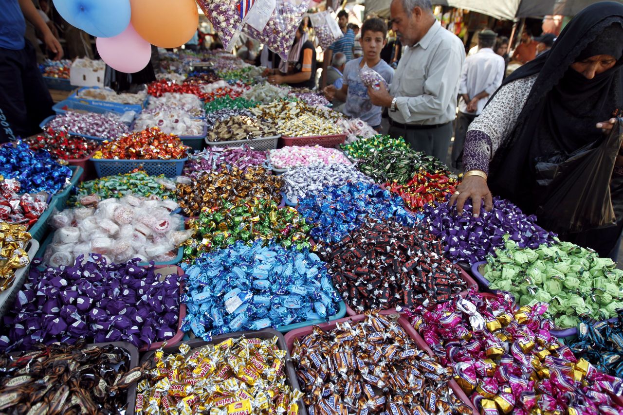 A Palestinian woman buys sweets in preparation for Eid al-Adha in Gaza City on Thursday.