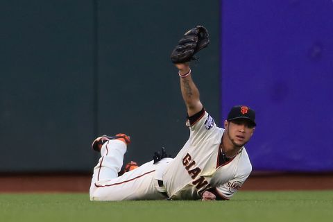 Gregor Blanco of the San Francisco Giants makes a diving catch in left field during the third inning.