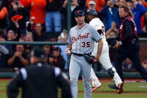 Justin Verlander of the Detroit Tigers grimaces as Pablo Sandoval of the San Francisco Giants rounds the bases after hitting a solo home run in the first inning.