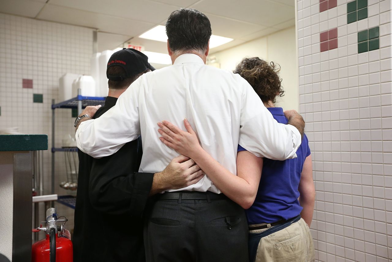 Romney, center, poses for a photo with workers at First Watch Cafe on Thursday. 
