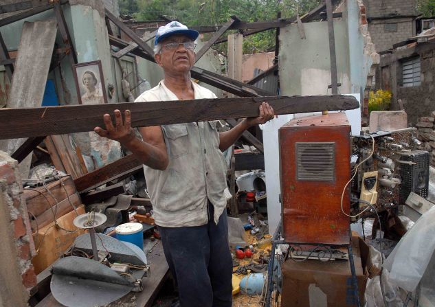 A  man clears debris from his house on Thursday. It was demolished by Hurricane Sandy in Santiago de Cuba.