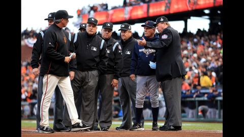 Manager Bruce Bochy, left, of the San Francisco Giants, and manager Jim Leyland, right, of the Detroit Tigers, go over ground rules with the umpires prior to the game.