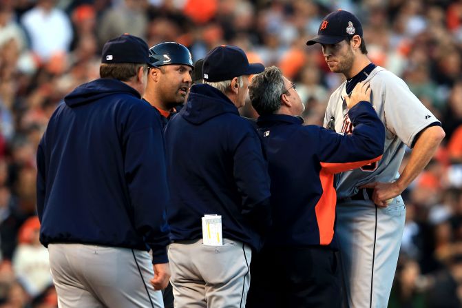 Doug Fister of the Detroit Tigers is checked by Tigers team trainer Kevin Rand after he was hit in the head by a ball off the bat of Gregor Blanco of the San Francisco Giants in the second inning.