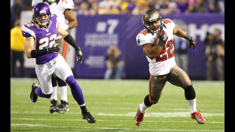 Doug Martin of the Tampa Bay Buccaneers runs up the field with Harrison Smith of the Minnesota Vikings in pursuit Thursday.