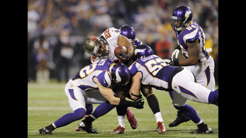 Doug Martin of the Tampa Bay Buccaneers is stopped by the Vikings defense as he runs the ball on Thursday.