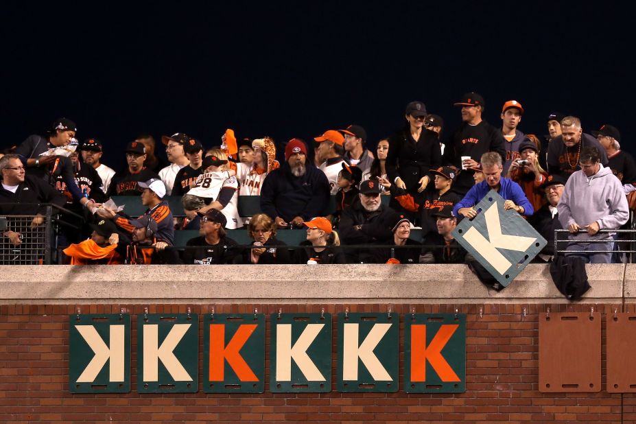 Giants fans hang "K" signs on the outfield wall for the number of strike-outs recorded by pitcher Madison Bumgarner.