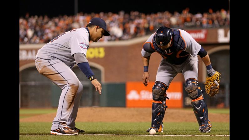 Miguel Cabrera, left, and Gerald Laird of the Detroit Tigers wait to see if a ball hit by Gregor Blanco of the San Francisco Giants will roll foul or stay in play.