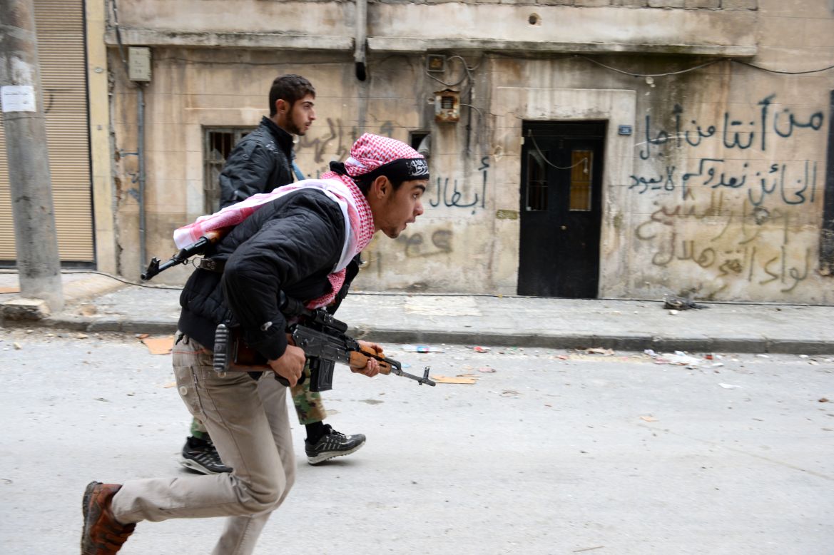 Syrian rebels run to take position in the Bustan al-Basha district in Aleppo on Friday. 