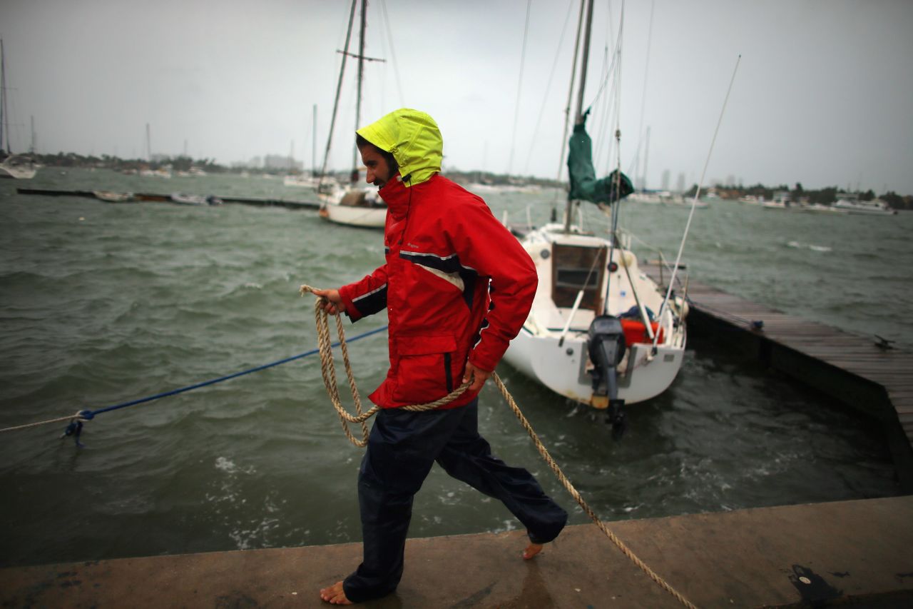 Corey Hutterli works on securing his sailboat as the outer bands of Hurricane Sandy are felt in Miami Beach, Florida, on Thursday, October 25.