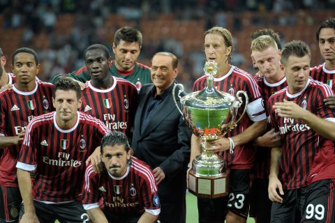Berlusconi, then owner of the Italian soccer club AC Milan, celebrates with the players after the team won the Luigi Berlusconi Trophy in August 2011. The trophy is in honor of Berlusconi's father.