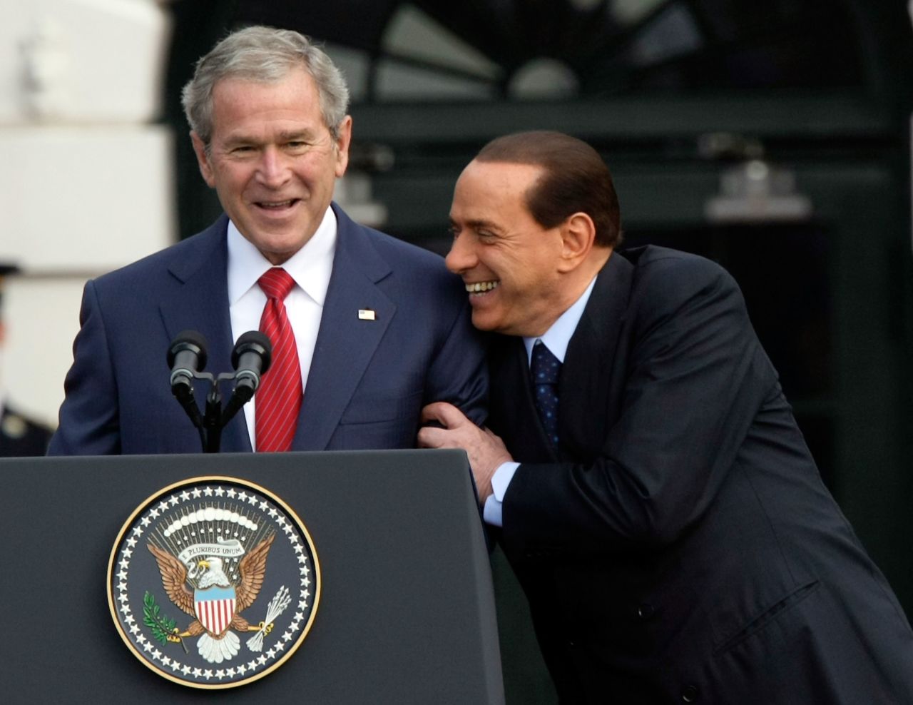 Berlusconi shares a moment with President George W. Bush during an arrival ceremony on the White House South Lawn in October 2008.