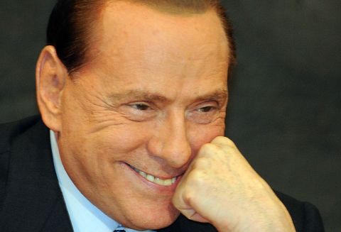 Berlusconi reacts during the presentation of  Antonio Razzi's book "My Clean Hands" at the Italian Parliament in February 2012.