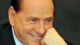 Berlusconi reacts during the presentation of politician Antonio Razzi's book "Le mie mani pulite" (My clean hands) at the Italian parliament in Rome on February 1, 2012.