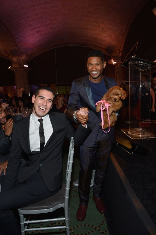 Usher holds a puppy at an event in New York City.