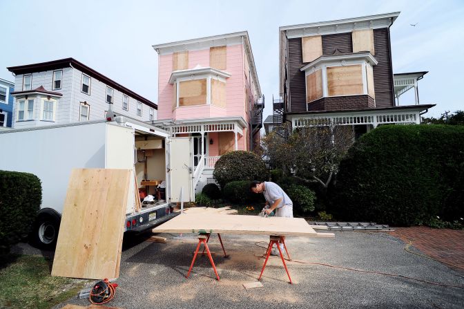 Burt Myrich boards up a home in preparation for Hurricane Sandy on Saturday in Cape May, New Jersey.