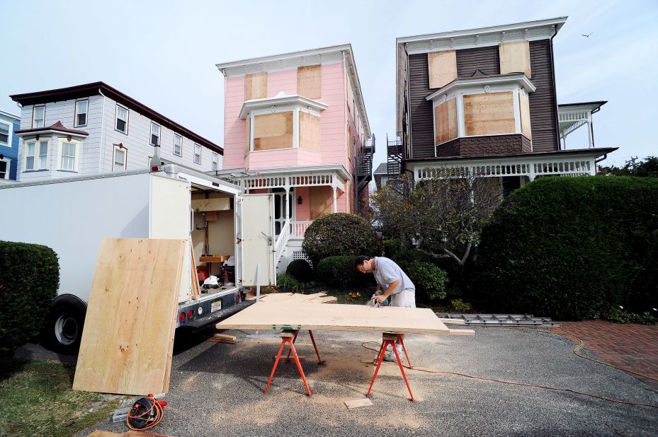 Burt Myrich boards up a home in preparation for Hurricane Sandy on Saturday in Cape May, New Jersey. 