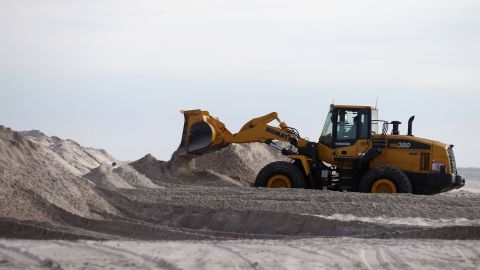 A bulldozer moves sand to help protect the shoreline in Long Beach, New York.