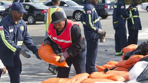 Workers pass sandbags at a distribution center near RFK Stadium in Washington on Saturday.